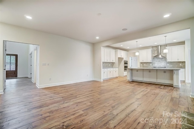 unfurnished living room with light wood-type flooring