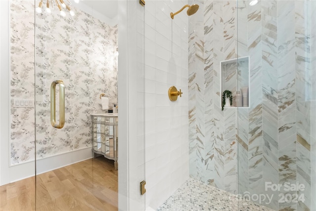 bathroom with wood-type flooring and walk in shower