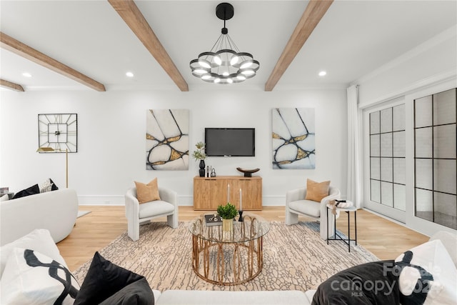 living room featuring beamed ceiling, light hardwood / wood-style flooring, and a chandelier