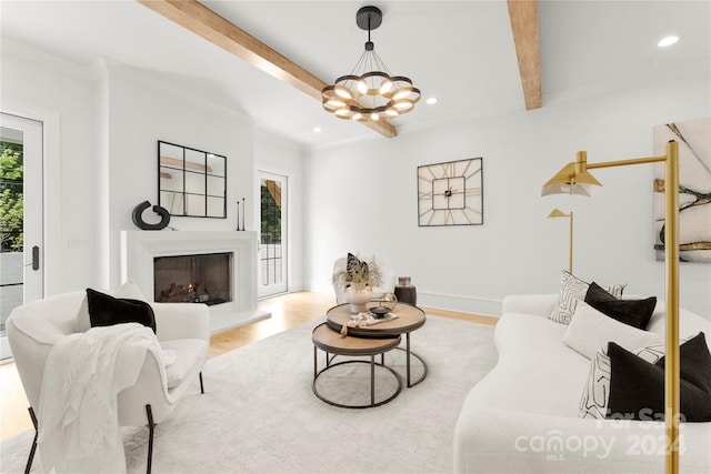 living room with a chandelier, beam ceiling, crown molding, and light hardwood / wood-style flooring