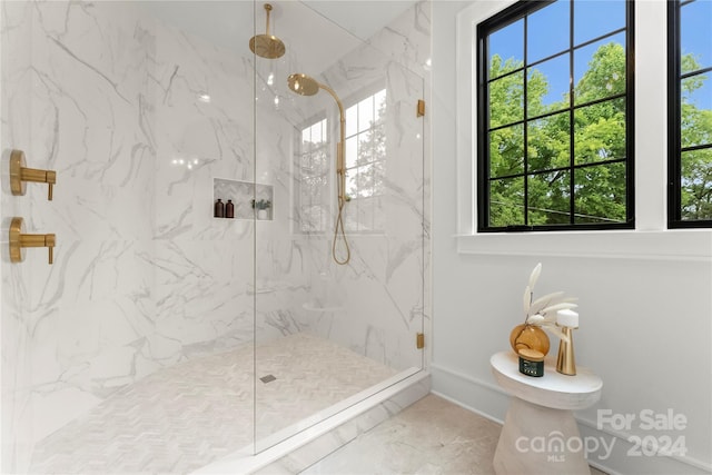 bathroom with tile flooring, tiled shower, and toilet