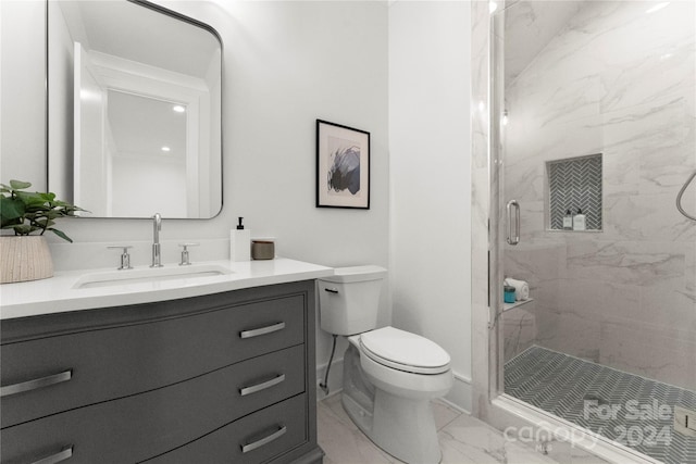 bathroom featuring walk in shower, vanity, toilet, and tile floors