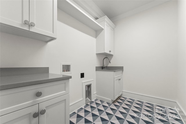 laundry area with cabinets, hookup for an electric dryer, hookup for a washing machine, sink, and light tile flooring