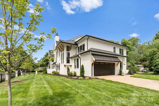 view of front of house featuring a garage and a front yard