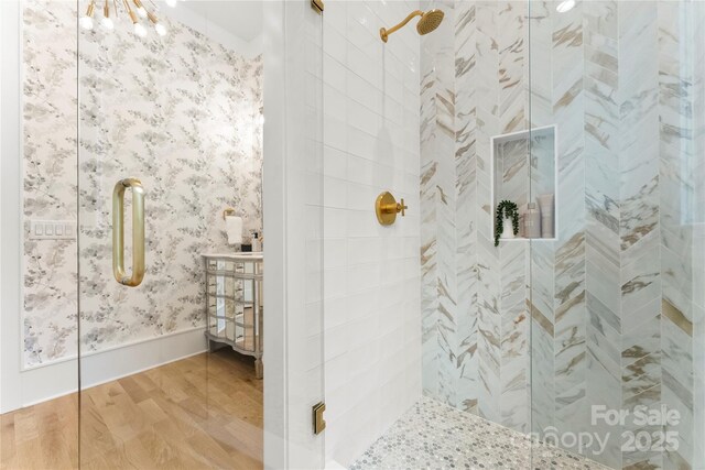 4142 Pineview Rd, Charlotte, NC 28211 - full bath featuring wood finished floors, tiled shower, wallpapered walls, and vanity