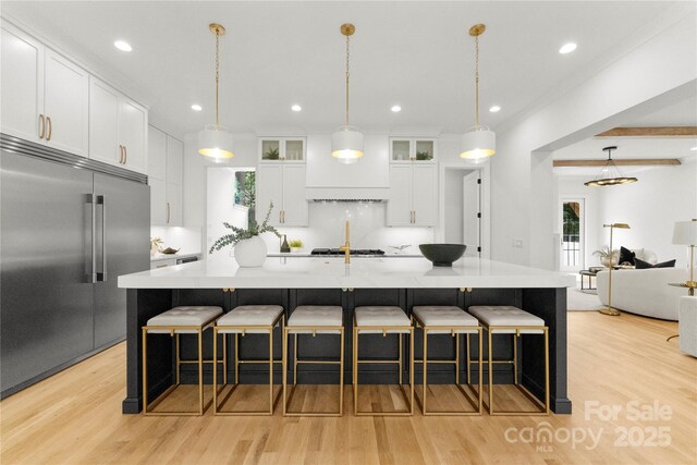 4142 Pineview Rd, Charlotte, NC 28211 - kitchen with built in fridge, light wood-type flooring, light countertops, white cabinets, and recessed lighting