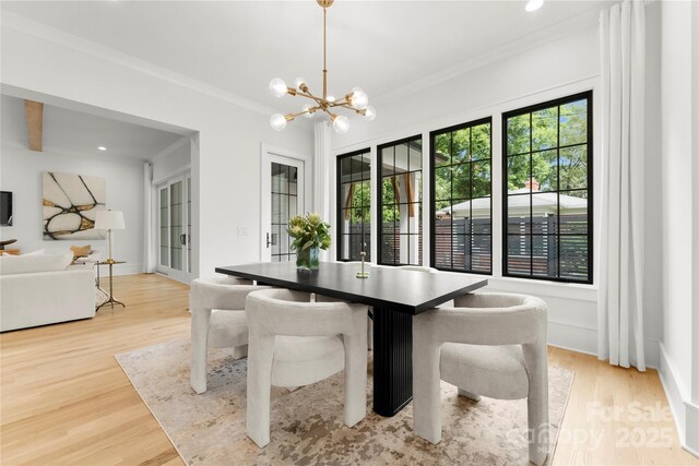 4142 Pineview Rd, Charlotte, NC 28211 - dining area featuring wood finished floors, a chandelier, ornamental molding, and recessed lighting