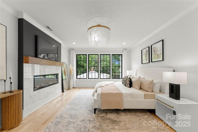4142 Pineview Rd, Charlotte, NC 28211 - bedroom featuring light wood-style floors, a tile fireplace, recessed lighting, ornamental molding, and baseboards