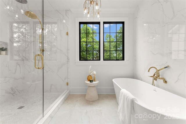 4142 Pineview Rd, Charlotte, NC 28211 - bathroom featuring a freestanding bath, a marble finish shower, baseboards, marble look tile flooring, and a chandelier