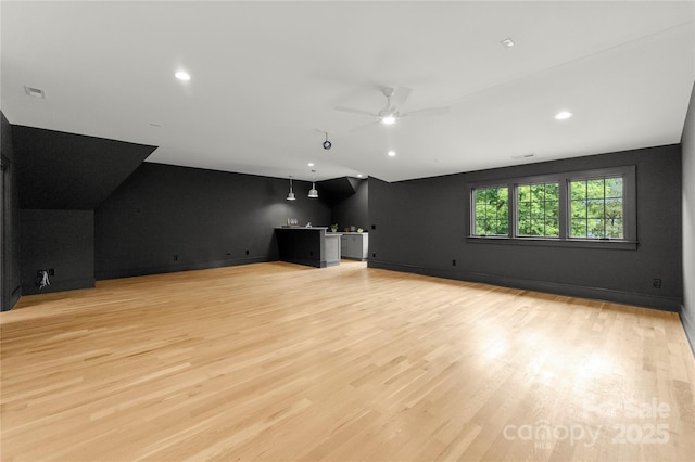 4142 Pineview Rd, Charlotte, NC 28211 - unfurnished living room with bar with sink, lofted ceiling, light wood-style floors, ceiling fan, and recessed lighting