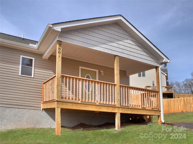 back of house with a wooden deck