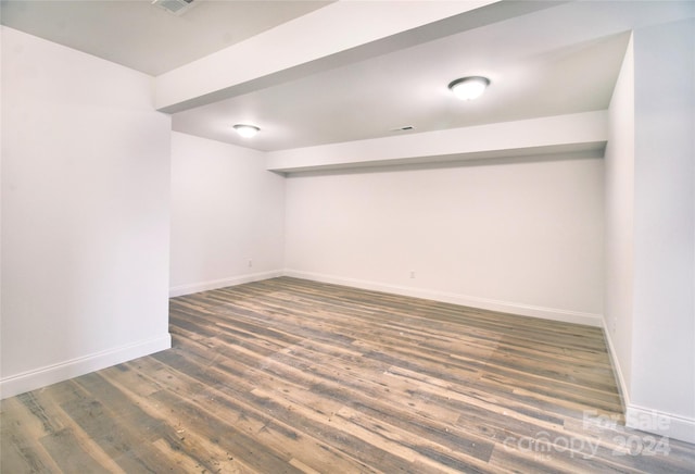 spare room with dark wood-type flooring