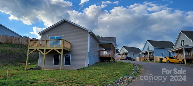 exterior space featuring a yard and a balcony