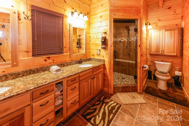 bathroom with tile flooring, wood walls, toilet, and a shower with shower door