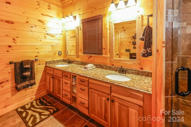 bathroom featuring tile floors, wooden walls, and dual vanity