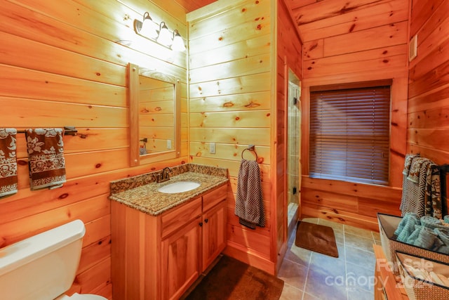 bathroom with tile flooring, large vanity, wooden walls, toilet, and wooden ceiling