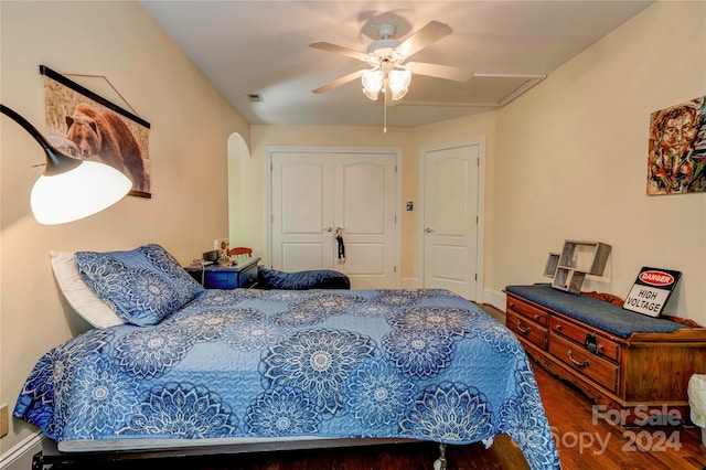 bedroom with dark hardwood / wood-style floors and ceiling fan