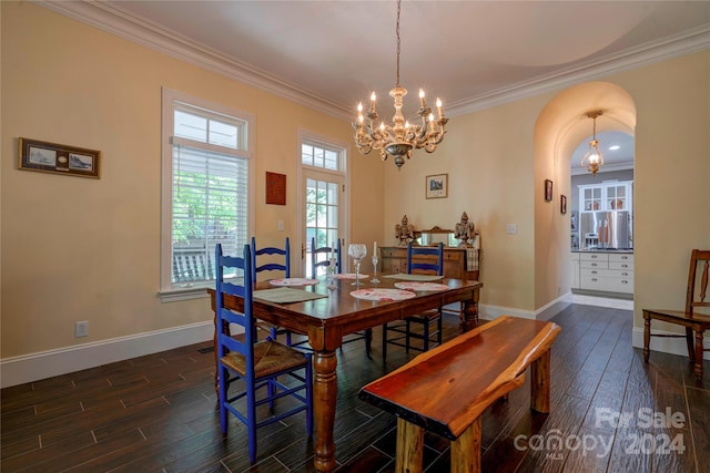 dining area with ornamental molding, dark wood-type flooring, and a notable chandelier