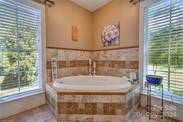 bathroom with tile patterned floors and tiled tub