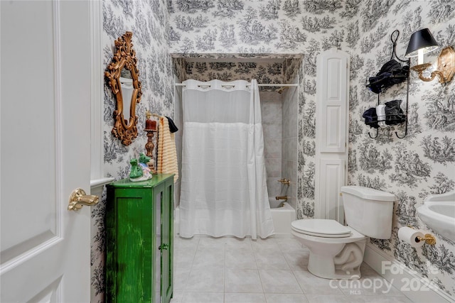 bathroom with tile patterned flooring, shower / bath combo, and toilet