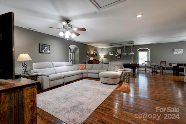 living room featuring ceiling fan, dark hardwood / wood-style flooring, and pool table