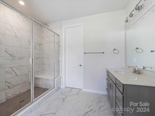 bathroom with a shower with door and vanity