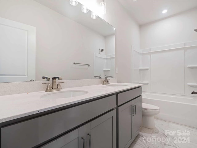 full bathroom with toilet, vanity, and shower / washtub combination