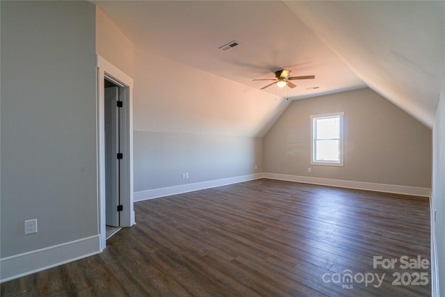 additional living space with lofted ceiling, dark hardwood / wood-style floors, and ceiling fan