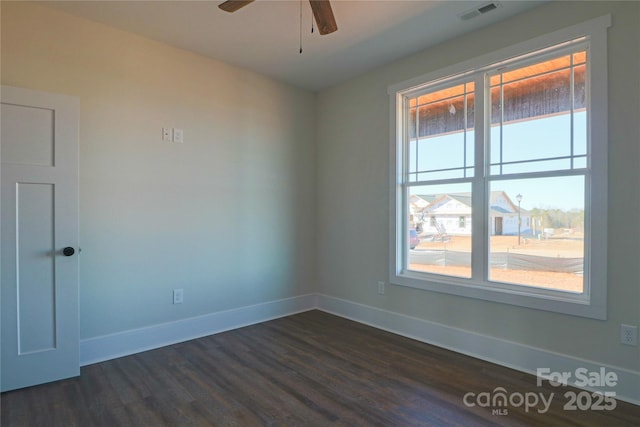 empty room with ceiling fan and dark hardwood / wood-style floors