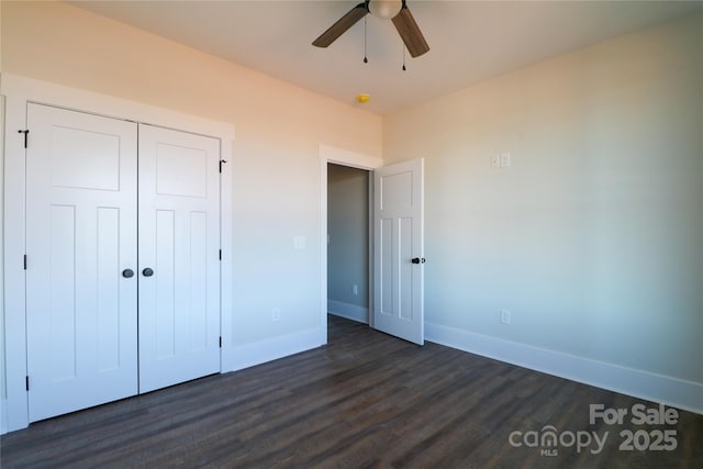 unfurnished bedroom featuring dark hardwood / wood-style floors, ceiling fan, and a closet