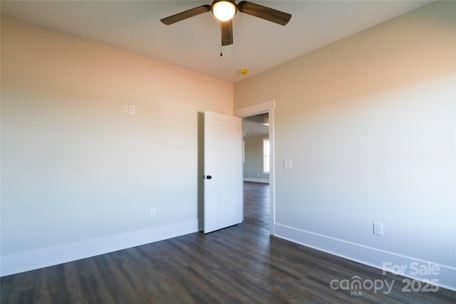 spare room featuring ceiling fan and dark hardwood / wood-style floors