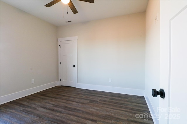 empty room with dark hardwood / wood-style floors and ceiling fan