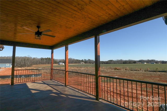 view of patio / terrace featuring ceiling fan and a rural view