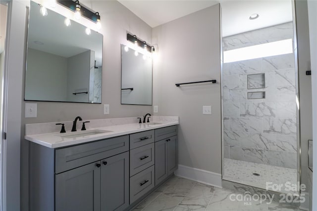 bathroom featuring tiled shower and vanity