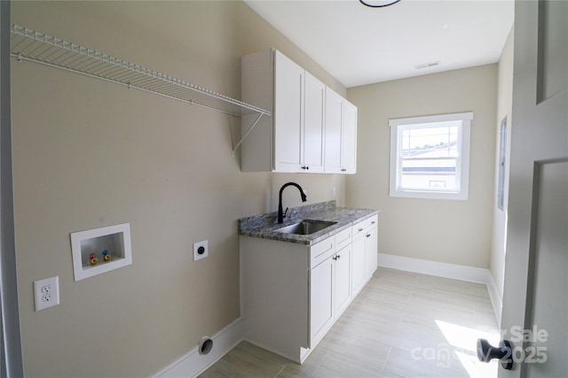 laundry room featuring washer hookup, sink, cabinets, and hookup for an electric dryer