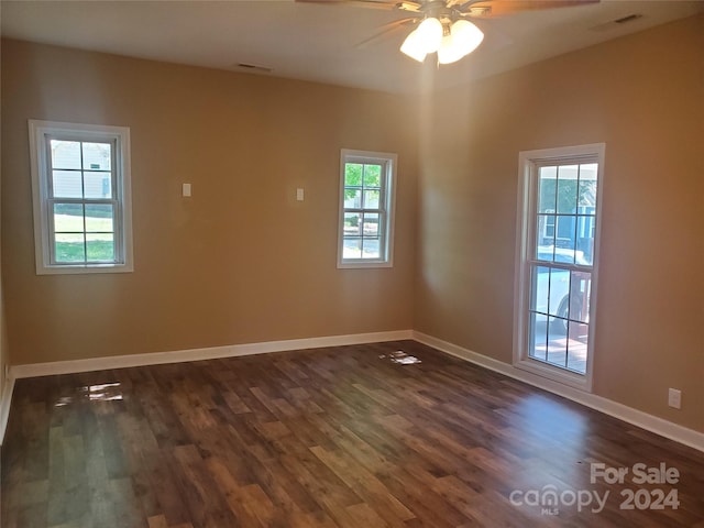 empty room featuring ceiling fan and dark wood-type flooring