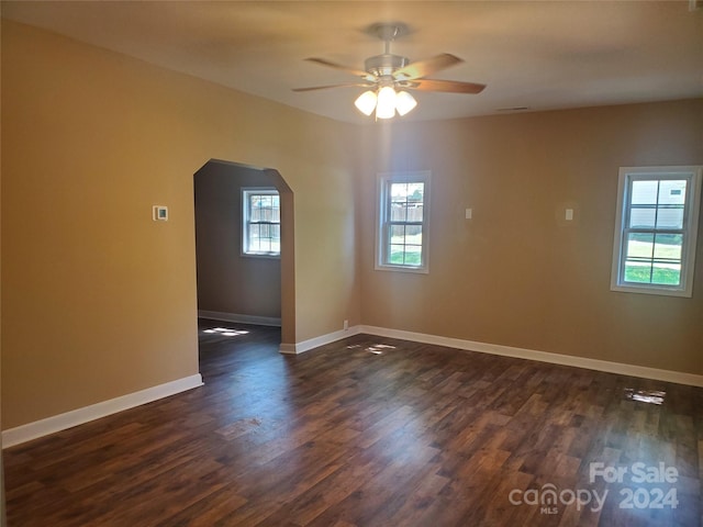 unfurnished room with dark hardwood / wood-style floors and ceiling fan