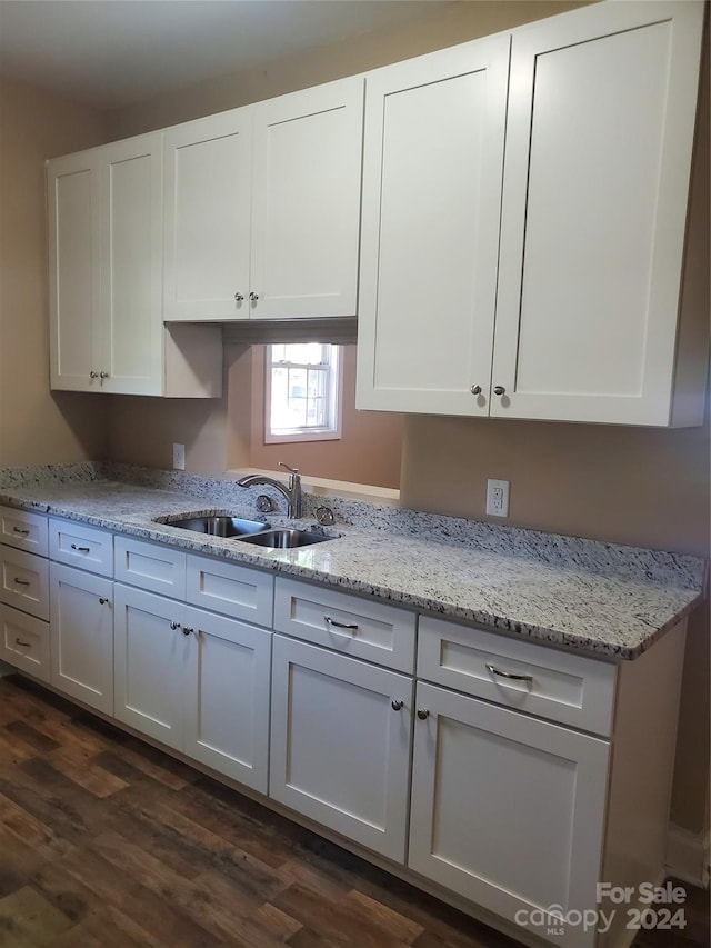 kitchen featuring white cabinets, dark hardwood / wood-style floors, sink, and light stone countertops