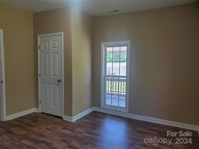 spare room featuring dark hardwood / wood-style floors