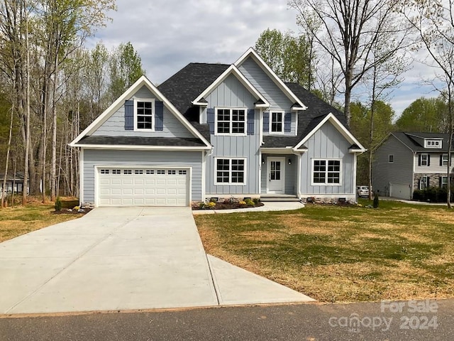 craftsman house featuring a front yard and a garage