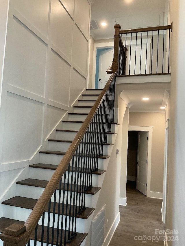 stairway with hardwood / wood-style flooring