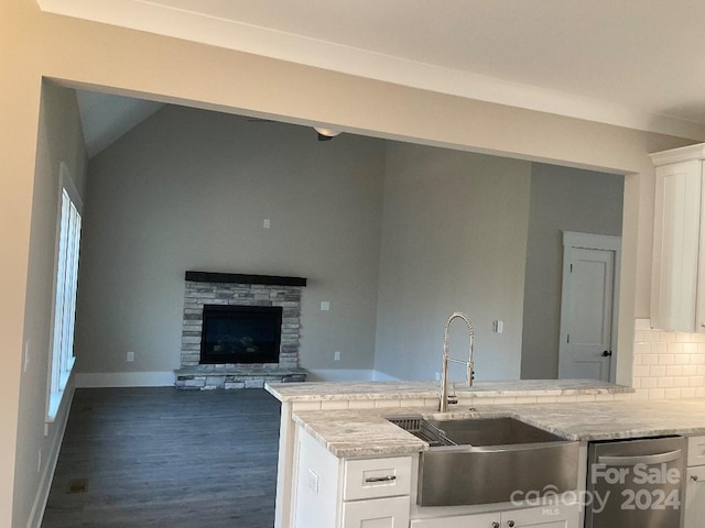 kitchen featuring white cabinetry, dark hardwood / wood-style flooring, vaulted ceiling, and backsplash