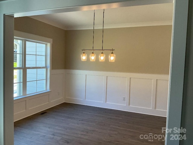 unfurnished dining area with dark hardwood / wood-style floors and crown molding