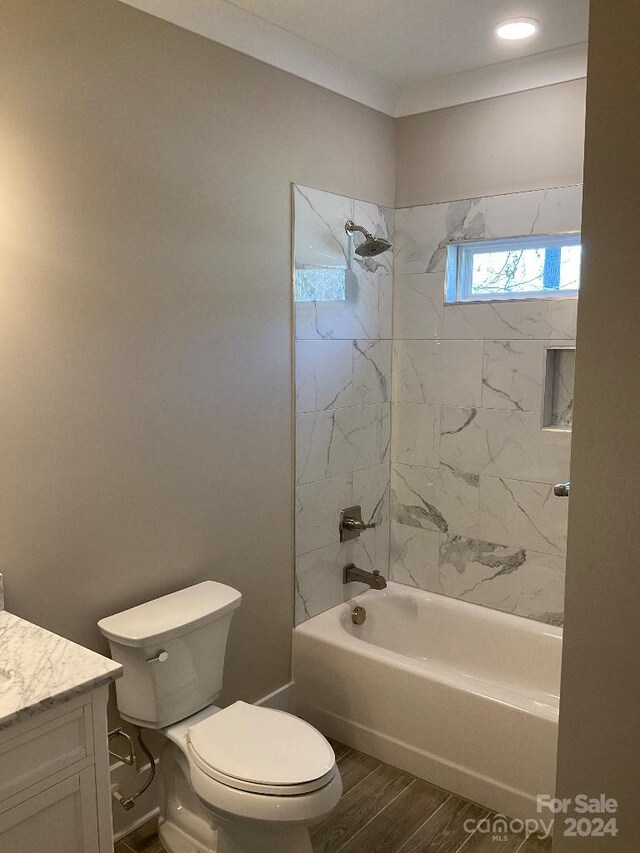 full bathroom with vanity, toilet, and tiled shower / bath