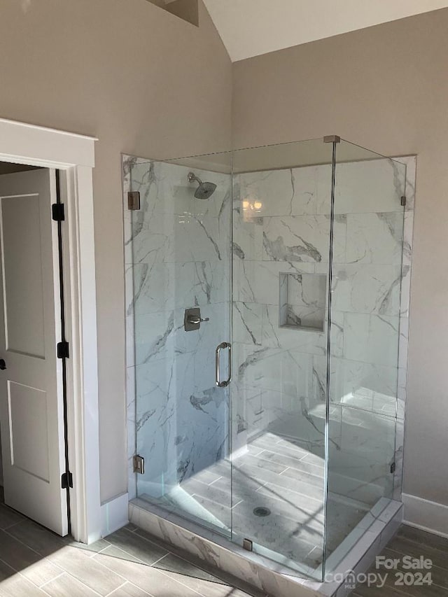 bathroom featuring hardwood / wood-style floors and walk in shower