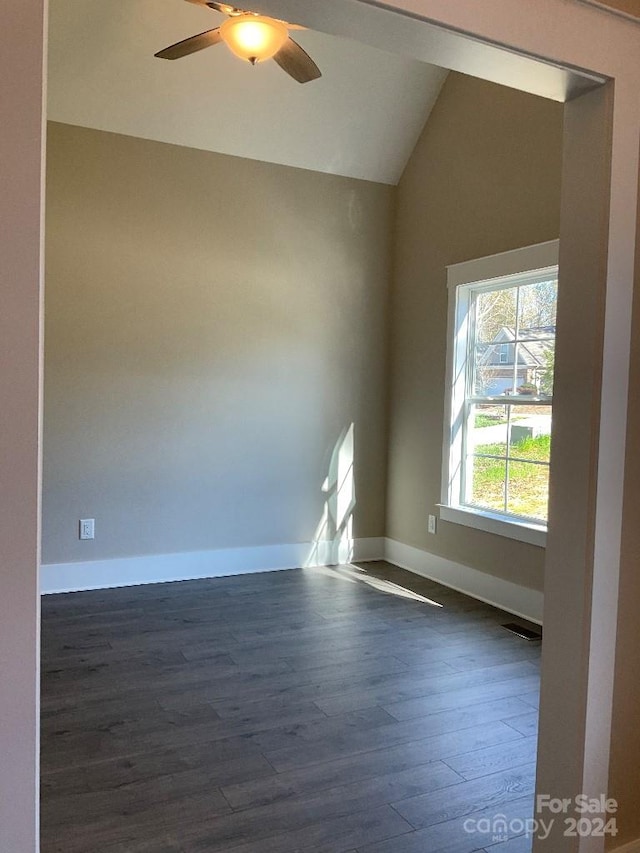 unfurnished room with dark wood-type flooring, lofted ceiling, and ceiling fan