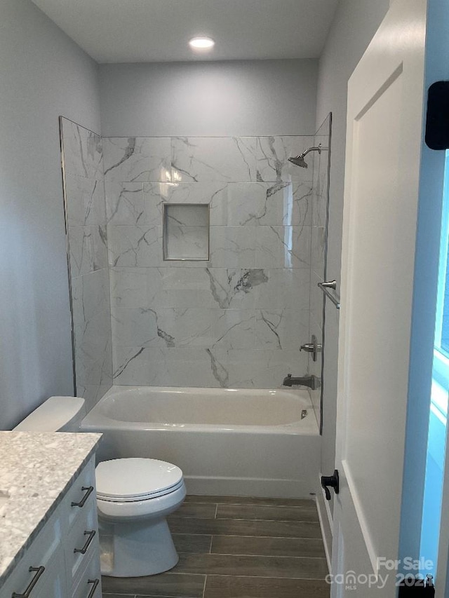 full bathroom with vanity, toilet, and tiled shower / bath