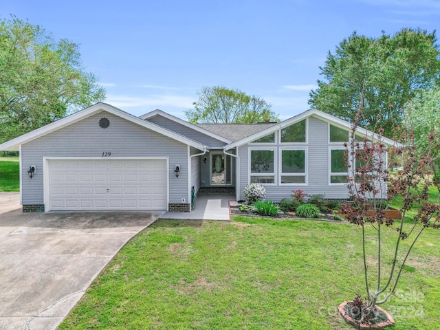 ranch-style house featuring a garage and a front yard