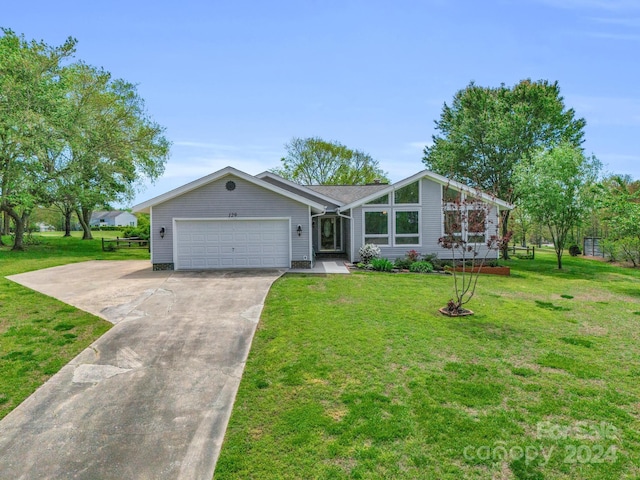 single story home with a front yard and a garage