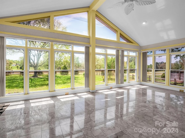 unfurnished sunroom with lofted ceiling with beams, ceiling fan, and a wealth of natural light